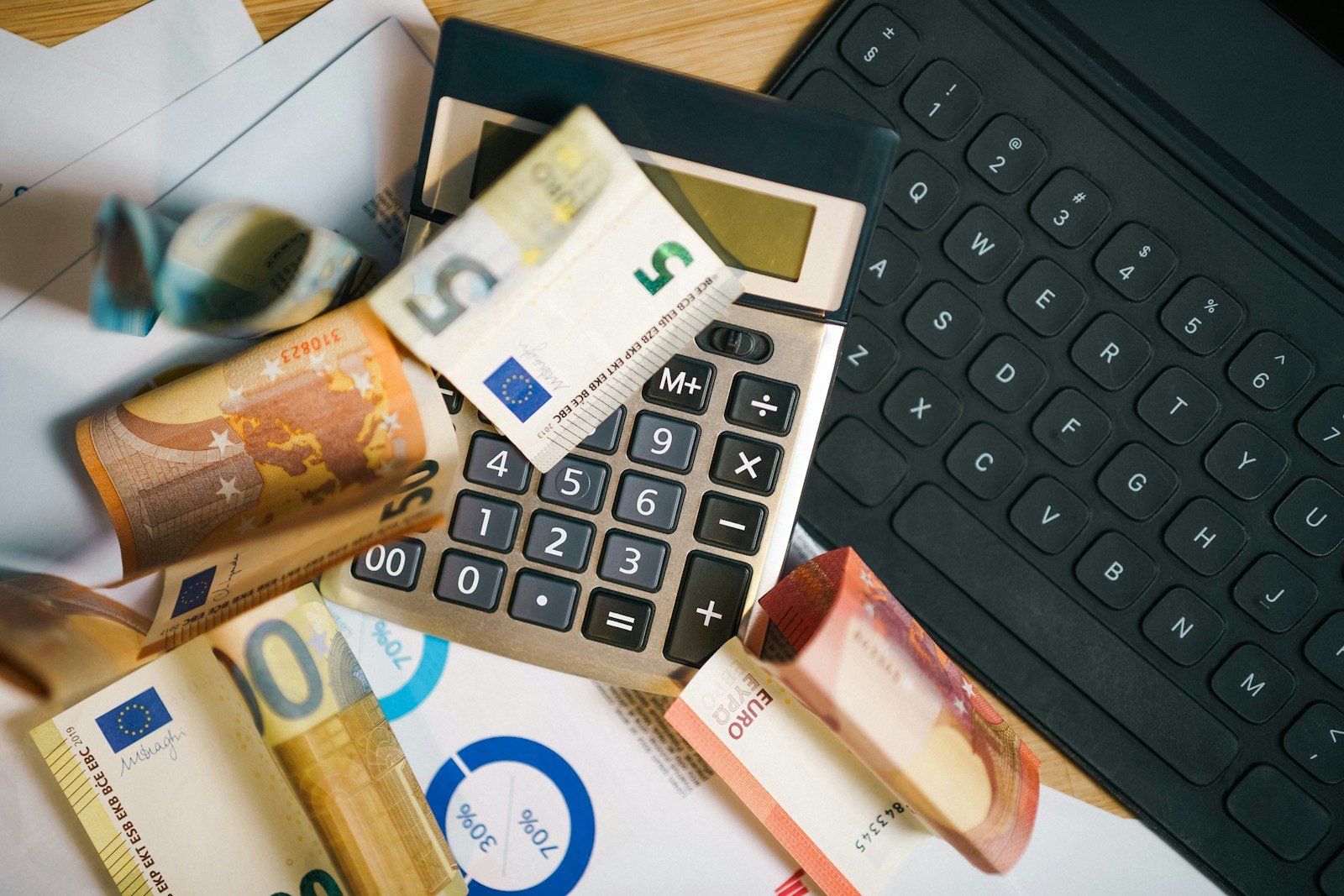 Euro banknotes and a calculator on a desk, working out tax relief on dental treatment