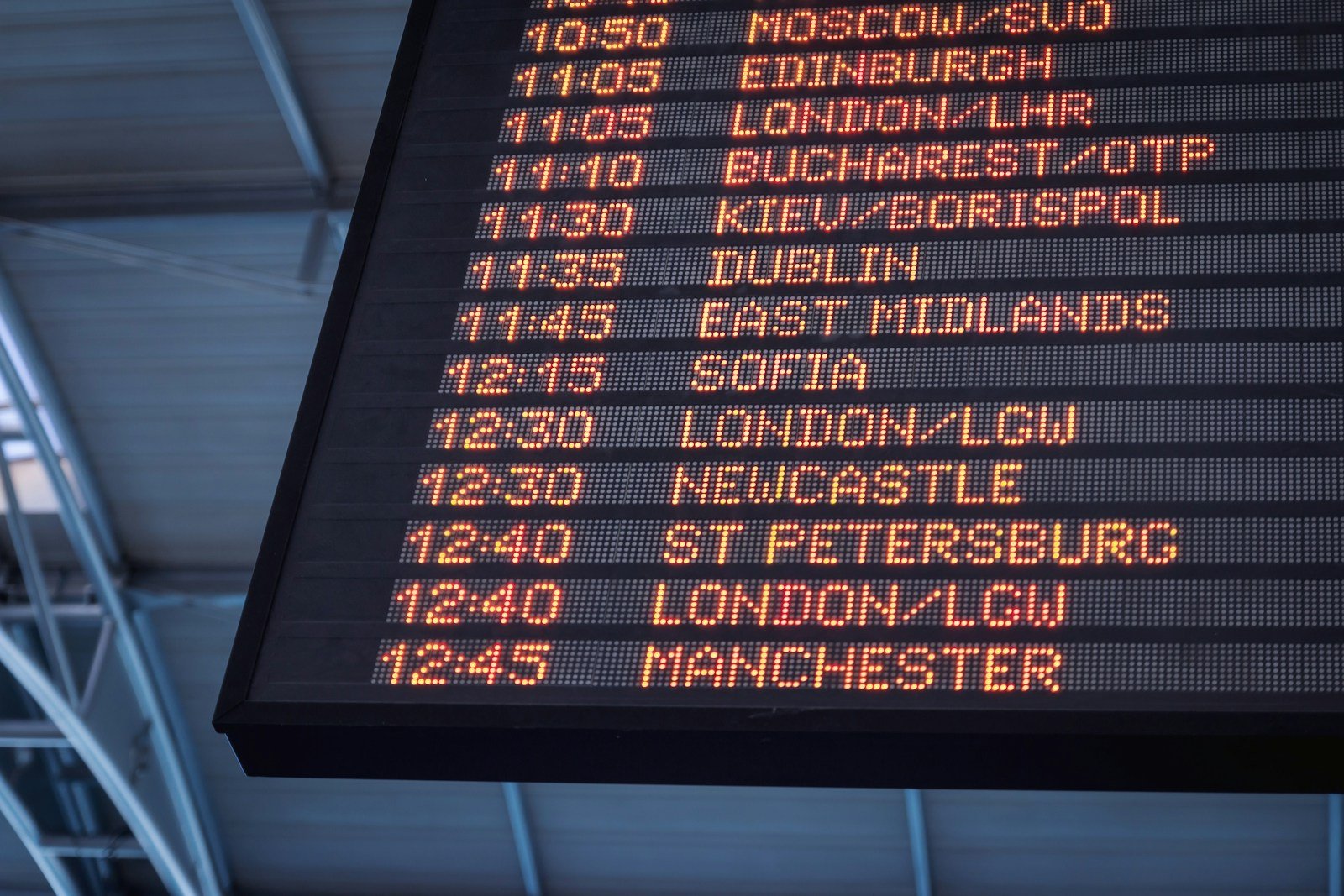 Airport departure board listing flights to London, Dublin, Manchester and other European cities